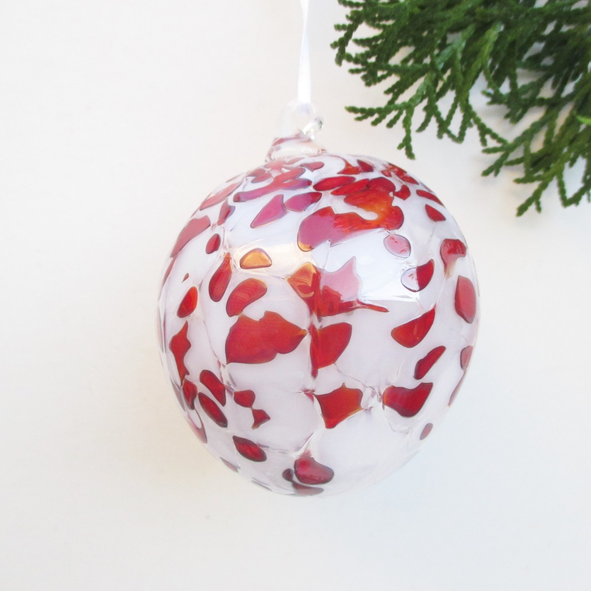red and whtie spotted christmas blown glass ornament